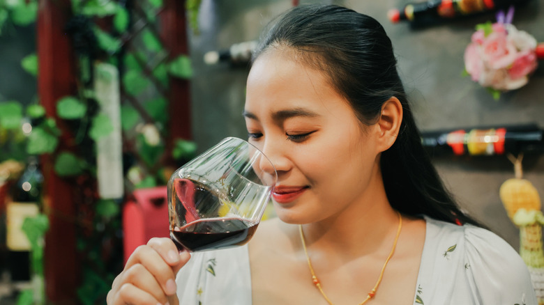 Woman sniffing wine