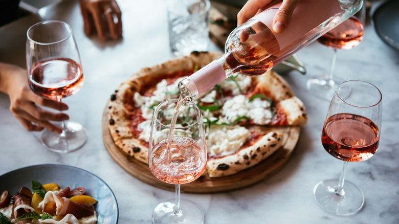 Glasses of rose and pizza