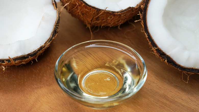 Coconuts with coconut oil in dish