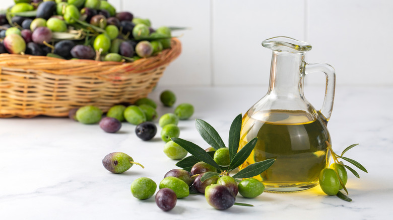 Olive oil on table with olives