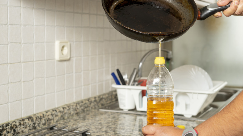 Pouring used oil back into bottle