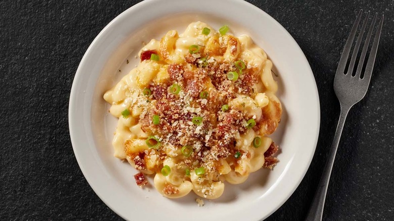 Bacon Mac and Cheese in a white bowl next to a fork