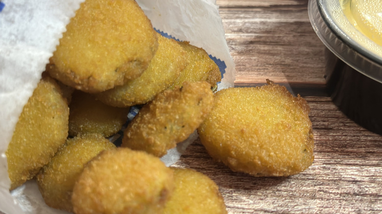Culver's Fried Pickles in a bag with cheese sauce on the side