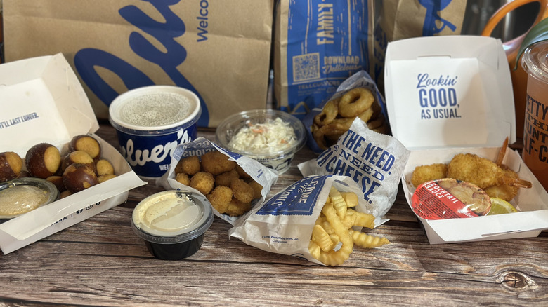 Several Culver's menu items in the packaging on a wooden table
