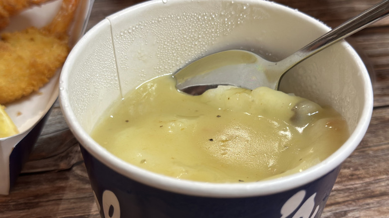 Culver's Medium Mashed Potatoes & Gravy in cup with spoon