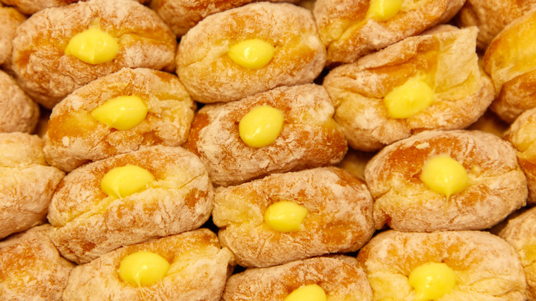 A row of donuts with yellow centers.