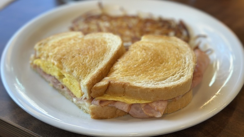 Moons Over My Hammy on white plate with hash browns