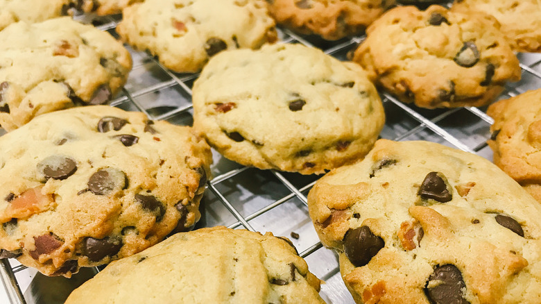 Freshly baked bacon chocolate chip cookies on a cooling rack