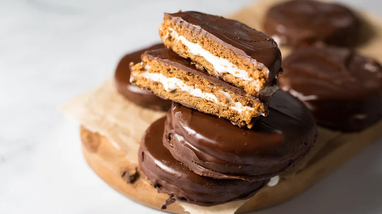 Homemade Chocolate MoonPies stacked on a board