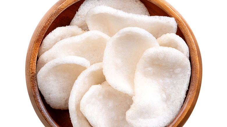 Bowl of prawn crackers on white background