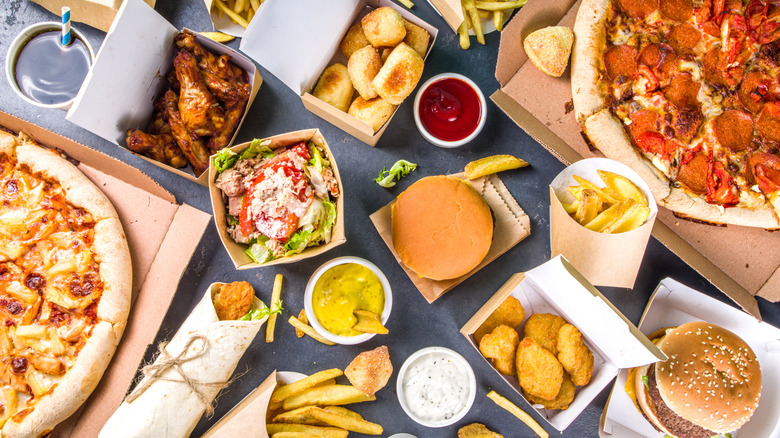 A large spread of fast food sits on a table