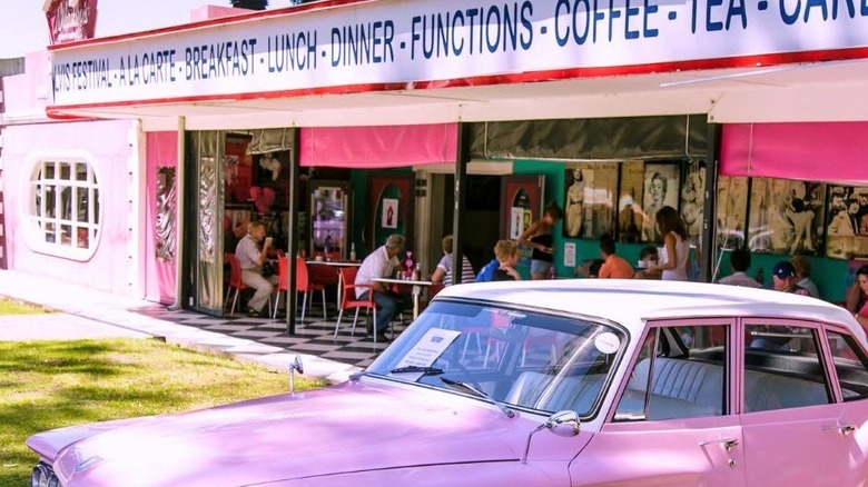 Outside of Marilyn's 60's Diner in South Africa, with pink vintage car out front