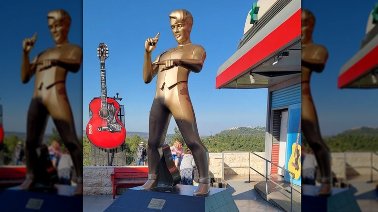 Giant golden Elvis statue with large red guitar outside of Elvis-themed café in Neve Ilan, Israel