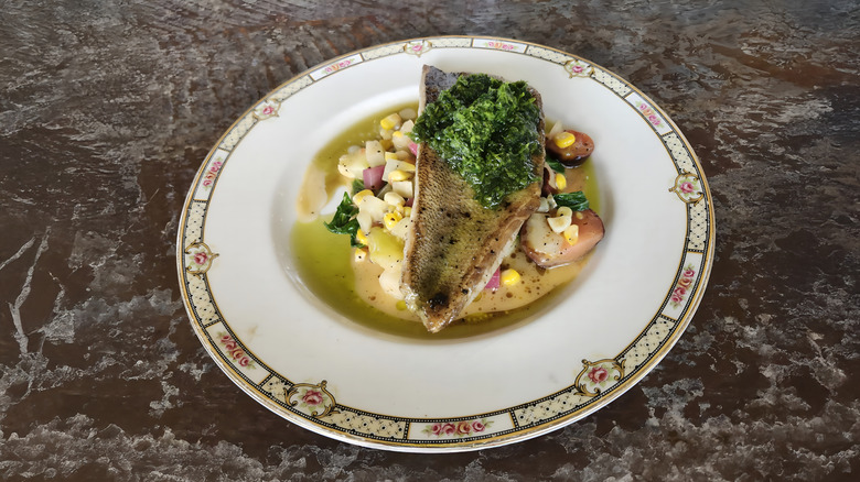 Arctic char on a plate of vegetables