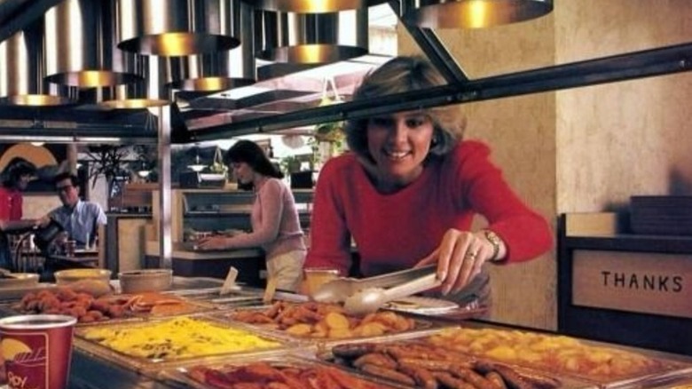 A woman in the 1980s serving herself at a Roy Rogers buffet
