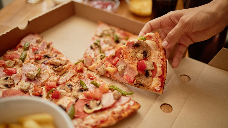 Sliced pizza in cardboard box