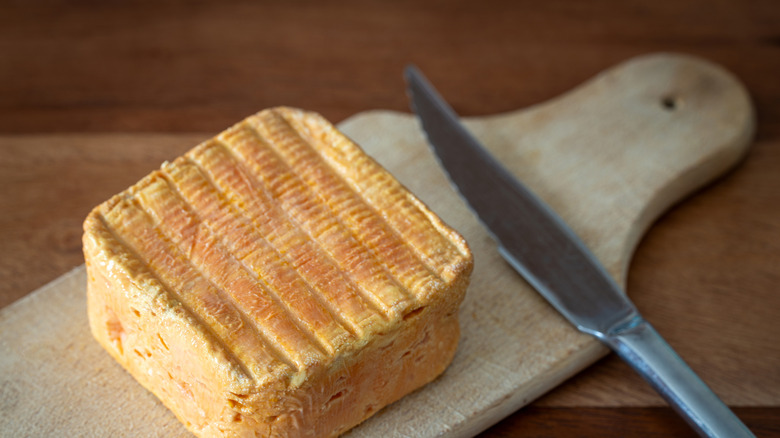 Limburger cheese on a cutting board with knife