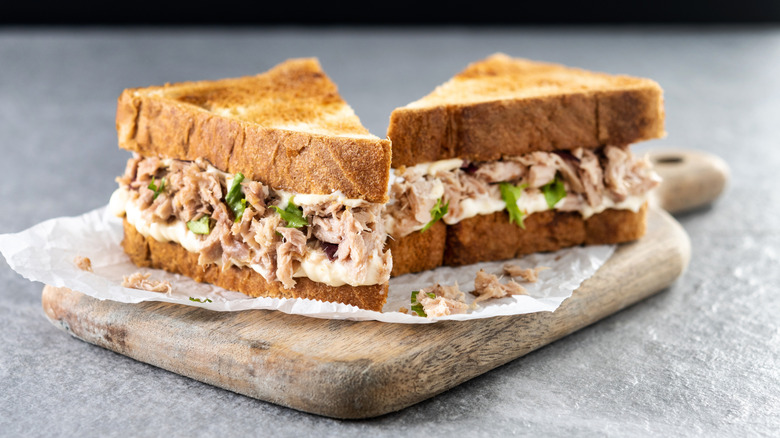 Tuna salad sandwich on a wood board