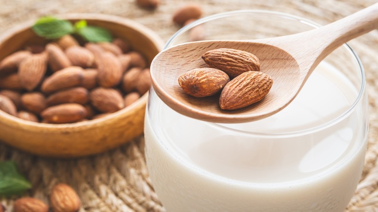 Almond milk and a spoon of almonds