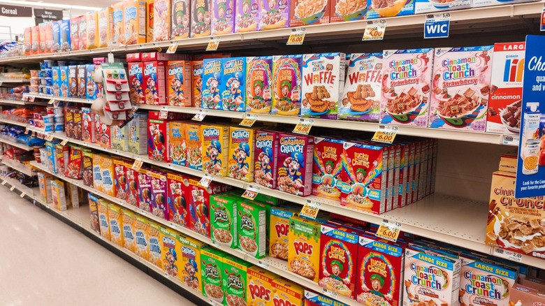 A selection of cereals on shelves in a grocery store