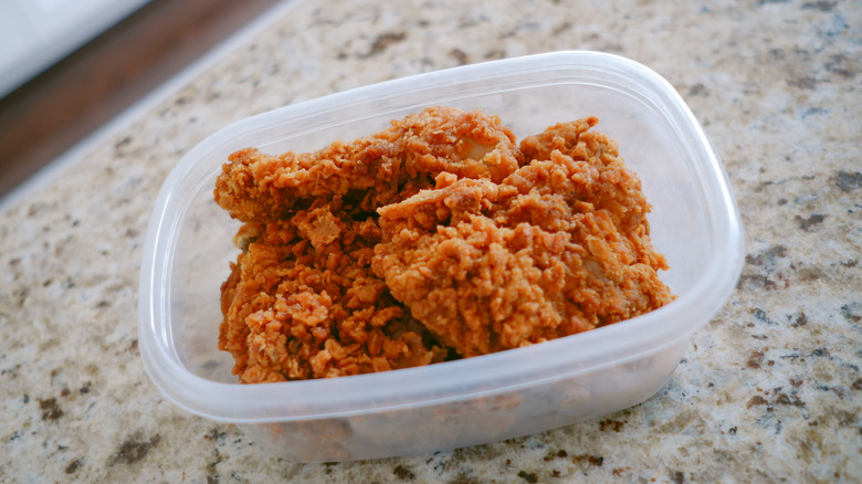 Leftover fried chicken in a container