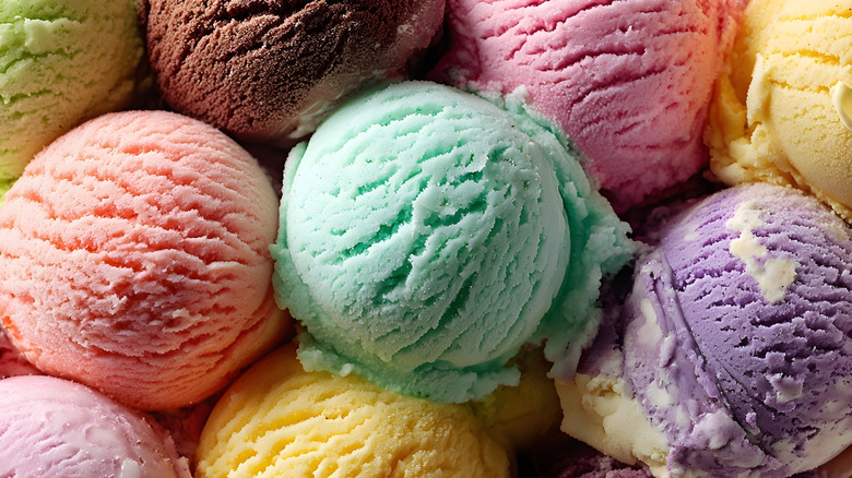 Scoops of various flavors of ice cream stacked together
