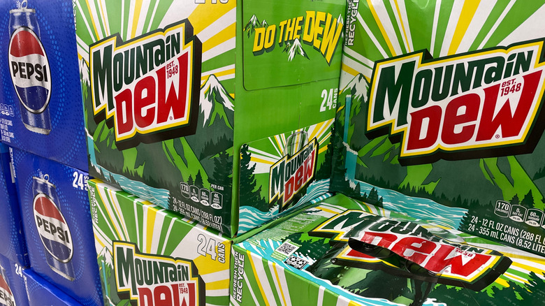 Stacks of 24-packs of Mountain Dew next to a stack of Pepsi