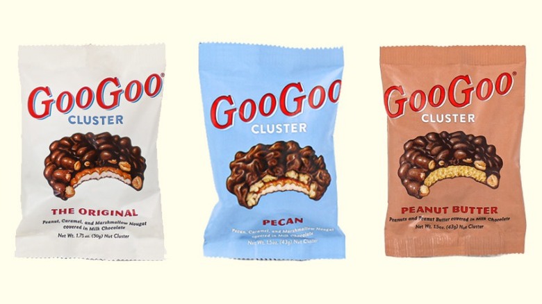 Bags of original, pecan, and peanut butter Goo Goo Clusters on a cream-colored background