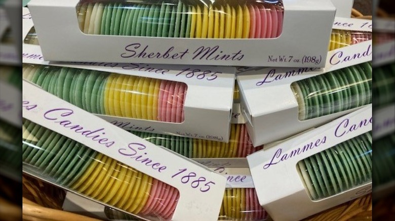 A close-up of packages of Lammes Candies Sherbet Mints in pastel white, green, yellow, and pink colors