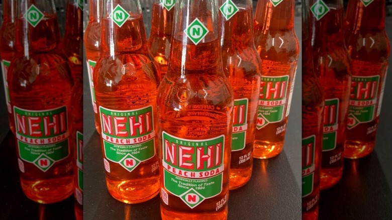Glass bottles of Nehi peach soda on a countertop