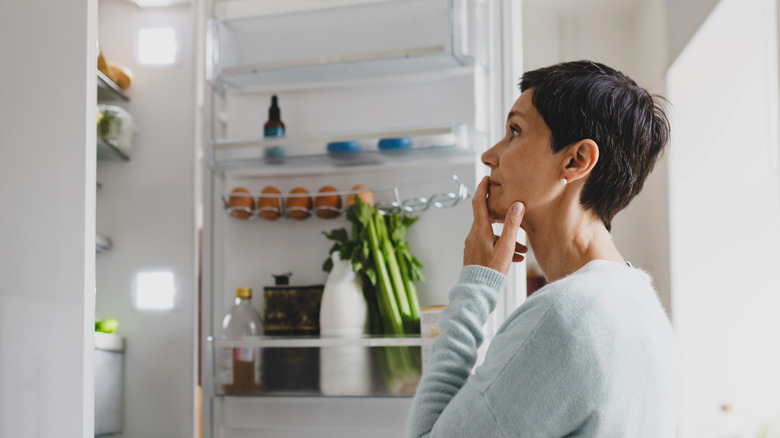 Woman looking inside a fridge