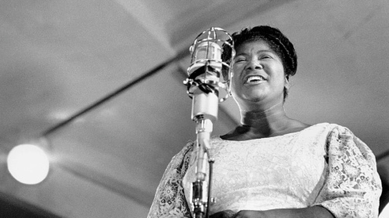 Mahalia Jackson sings at a microphone