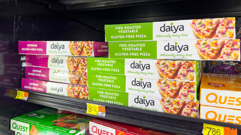 Boxes of Daiya frozen pizza on the store shelf