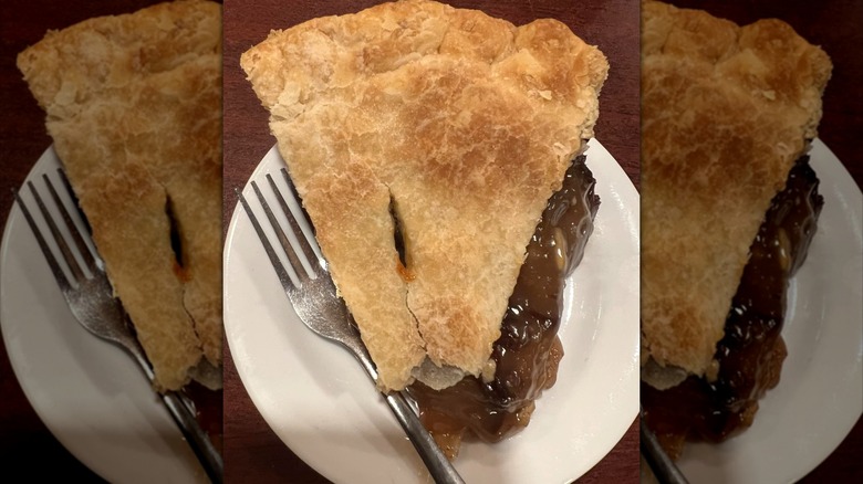 Slice of raisin pie with fork