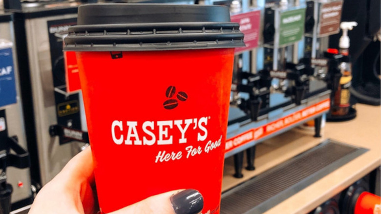 Hand holding cup of Casey's coffee