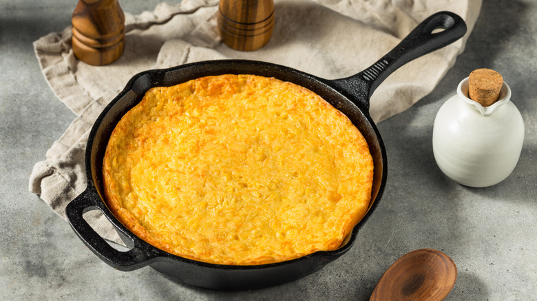 A cast-iron skillet of cornbread pudding