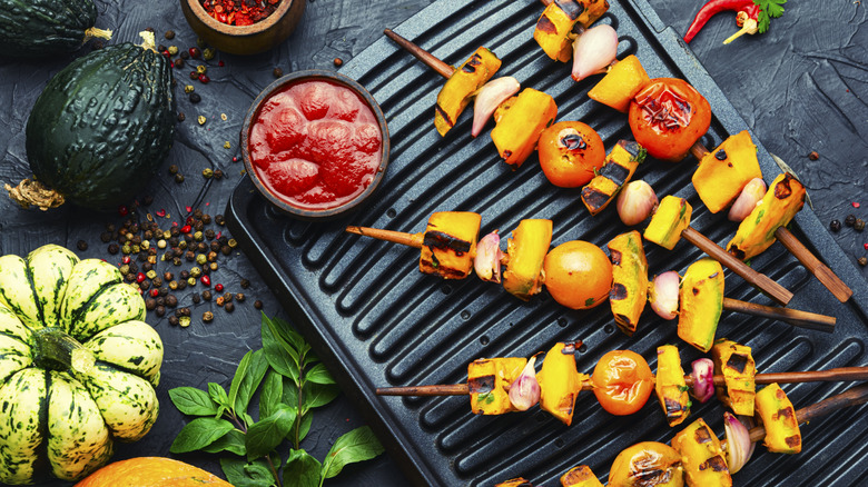 Fried vegetables on skewers, vegetable kebab. Pumpkin, tomato, zucchini, and pepper shashlik