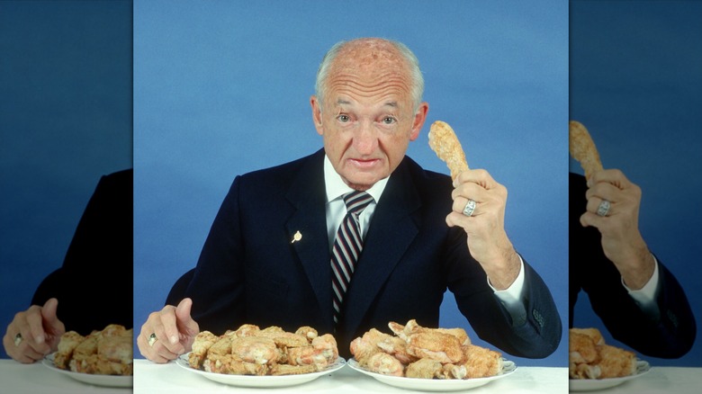 Frank Perdue posing with chicken in the 1980s, mirrored