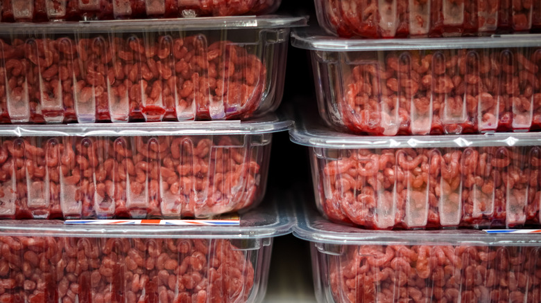 Shelf of ground beef trays in a supermarket