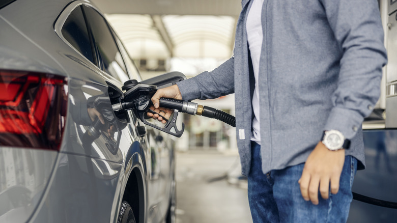 A person pumping gas into their car