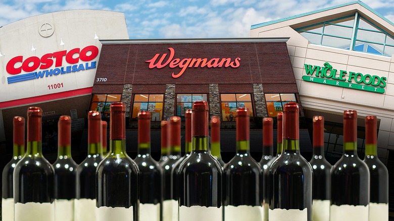 Wine bottles in front of signs for Costco, Wegmans, and Whole Foods