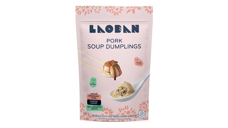 pink bag of Laoban pork soup dumplings with photo of chopsticks holding dumpling and floral design on package