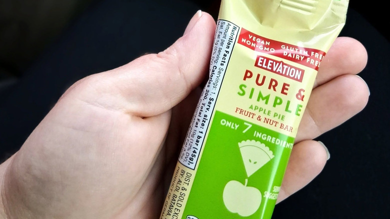 Somebody holding an Elevation Pure & Simple Apple Pie Fruit & Nut Bar