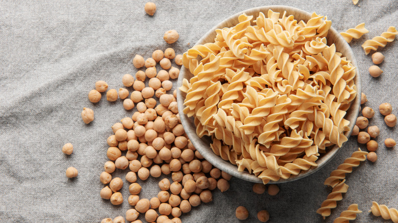 Chickpea bean fusilli pasta on a gray textile background.