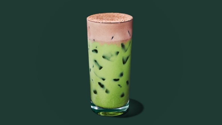 Starbucks Iced Dubai Chocolate Matcha on a forest green background.