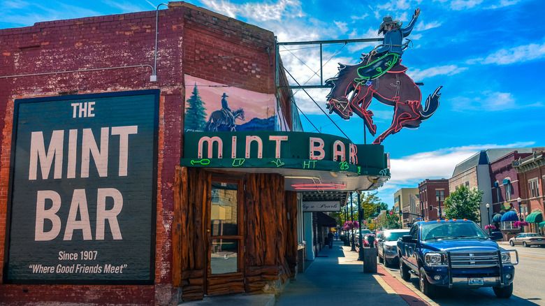 Cars are parked out front of The Mint Bar in Wyoming.
