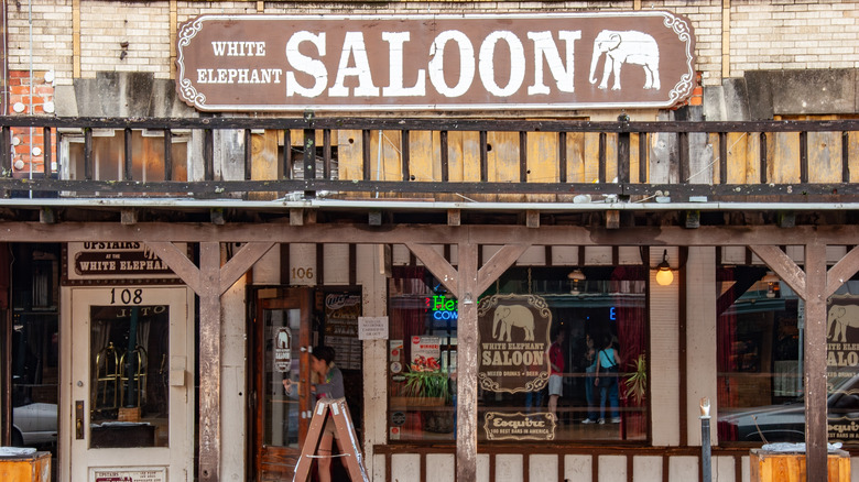 The sign outside the White Elephant Saloon hangs on the front.