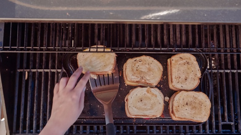 Grilling grilled cheese sandwiches on griddle-type grill.