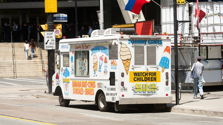 An ice cream truck parked on a street, day