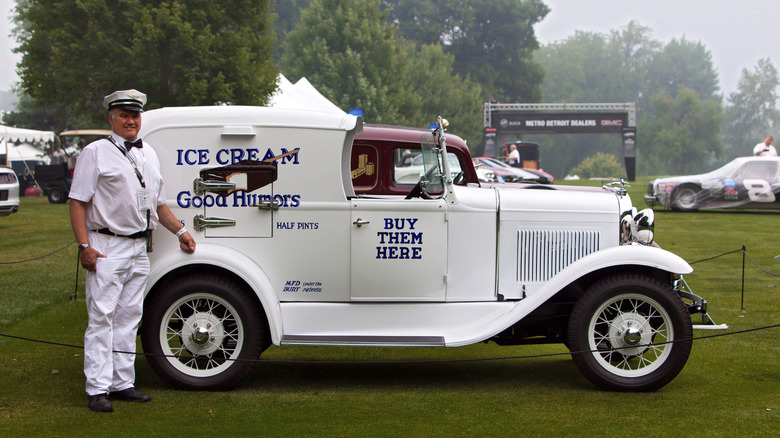 A man standing in front of an old-fashioned Good Humor ice cream truck